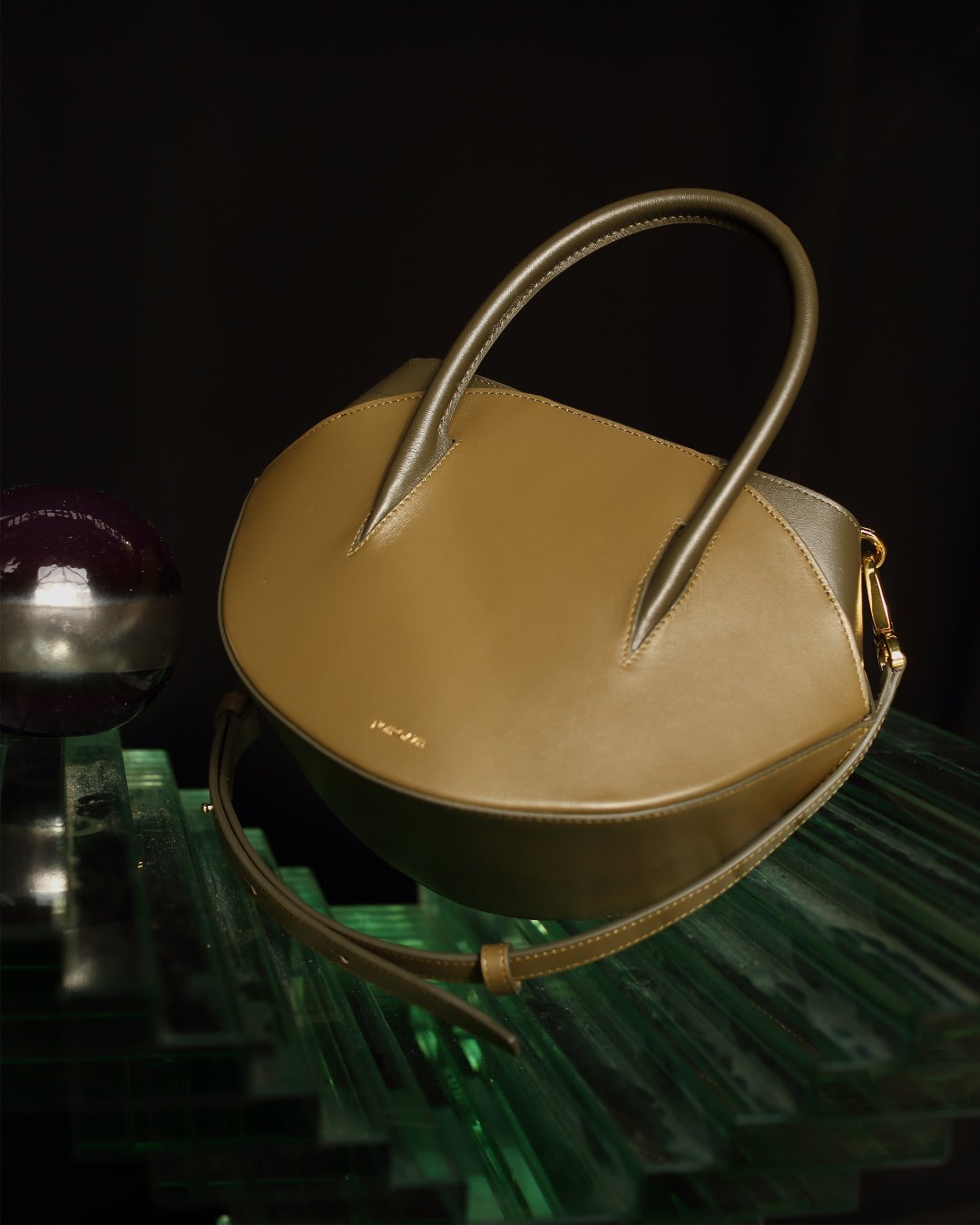 Maggie Bag in Olive Military color shown from a three-quarter angle highlighting its unique two-tone green leather panels